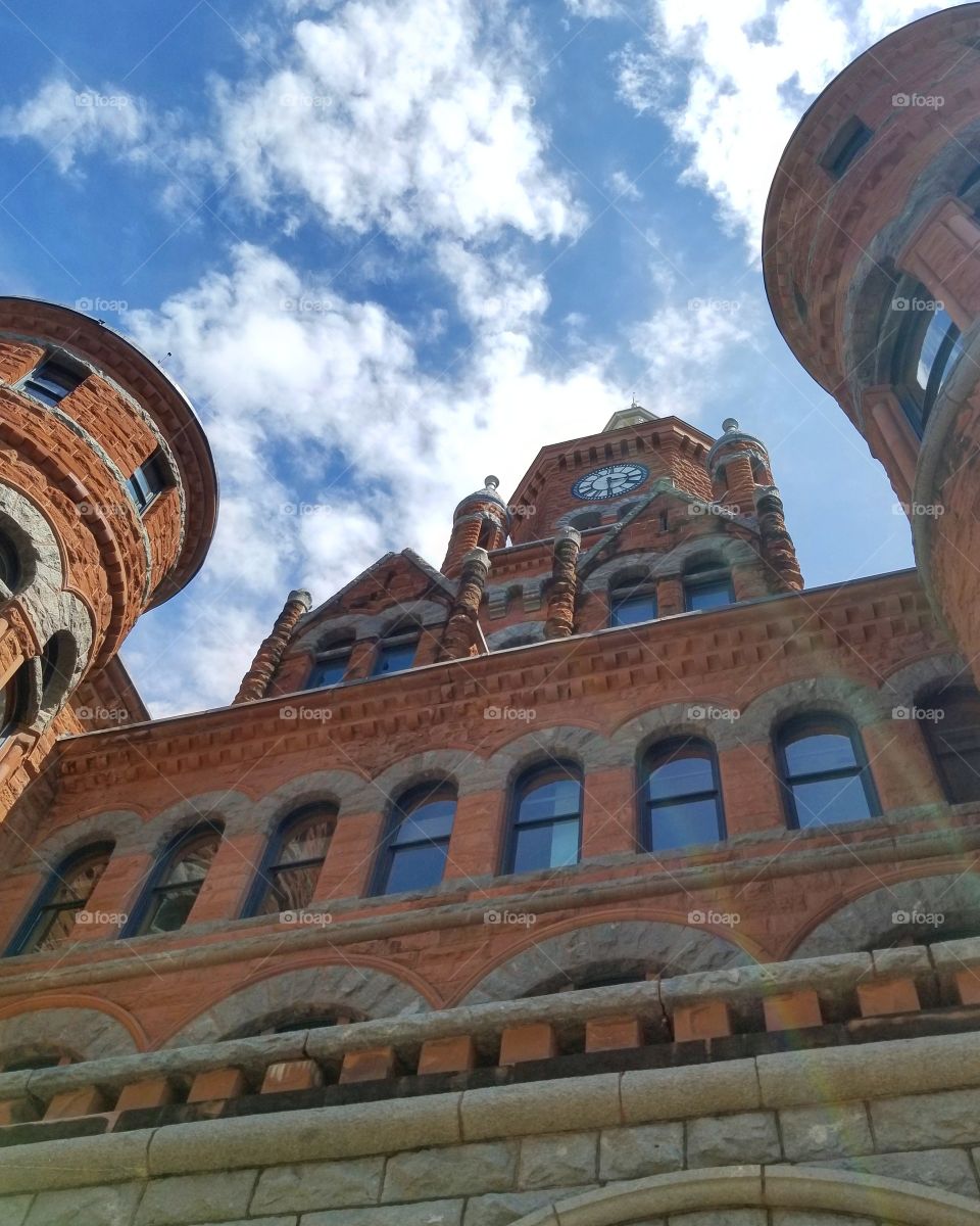 View from beneath red castle like museum on a sunny blue skies day in Dallas