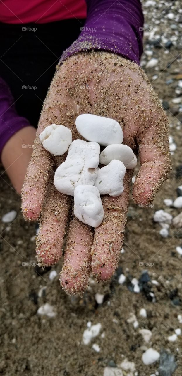 white stones in the hand