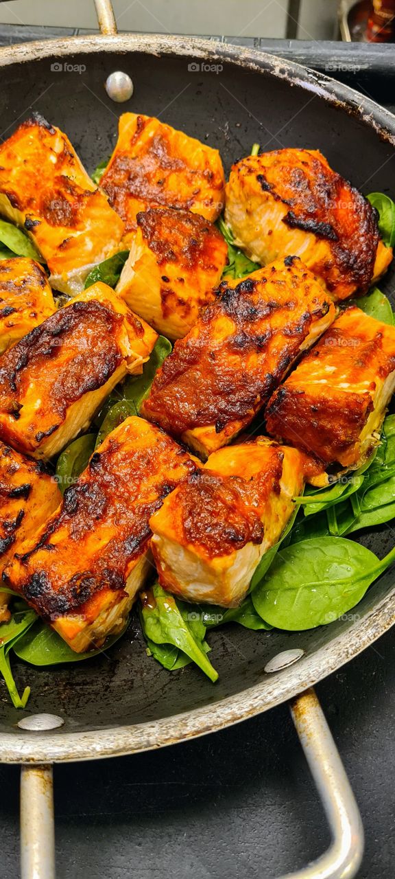 harissa baked salmon on a bed of spinach