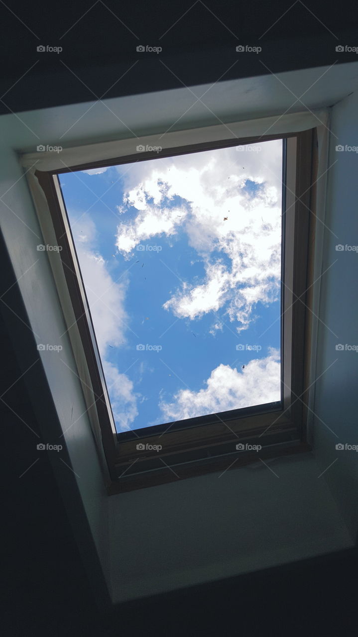 the blue sky with clouds in mansard window