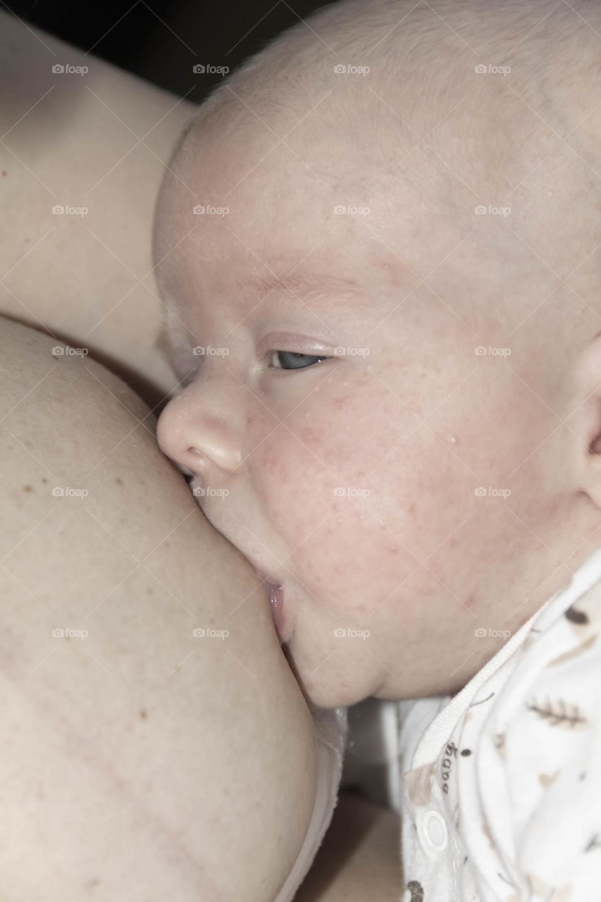A newborn baby on a yellow and gray background. A photo shoot in the style of Newborn and lifestyle.