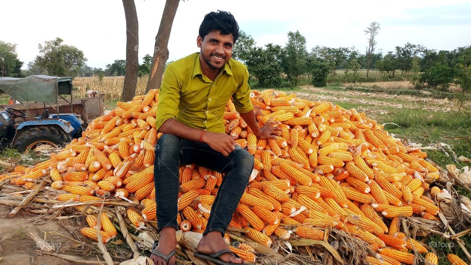 happy farmer with maize