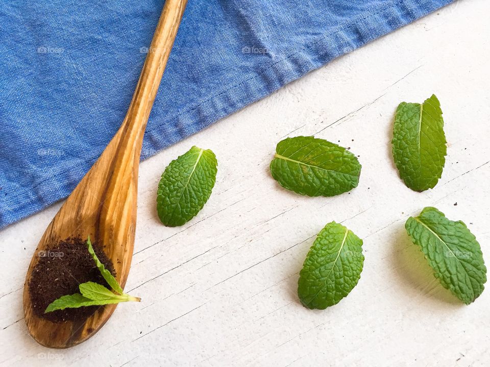 Herbal tea and mint leaves in spoon