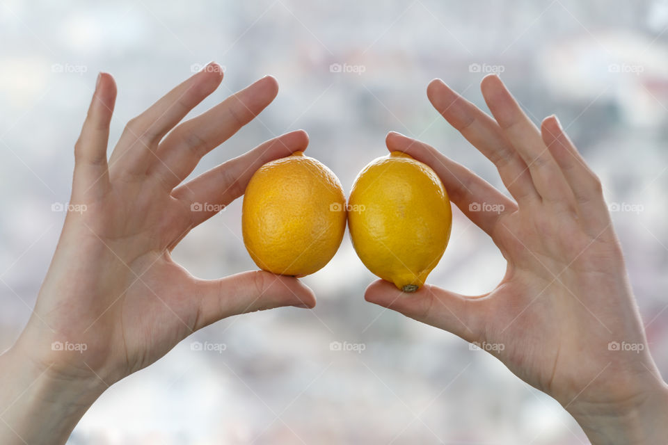 Close-up of a lemons in hands