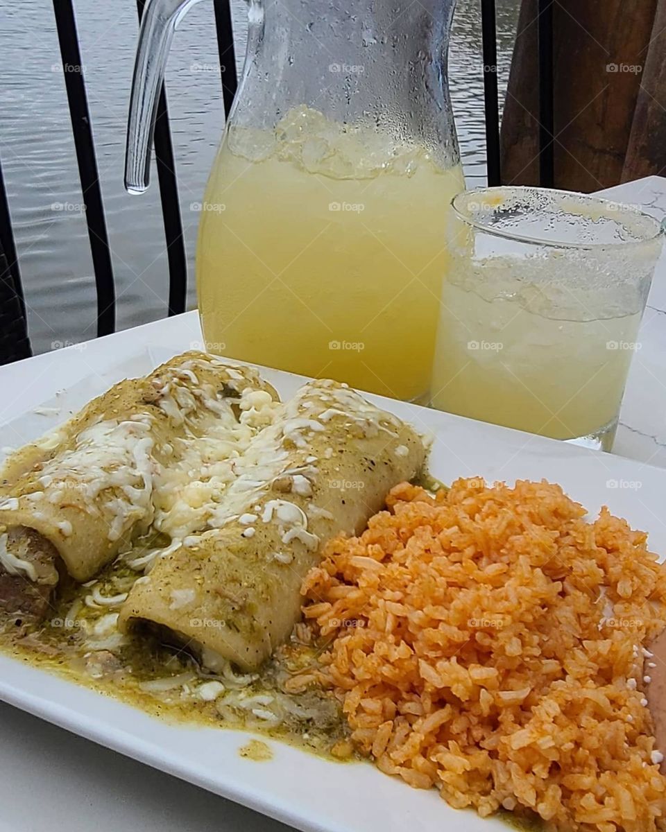 Delicious chili verde enchiladas with rice and beans Mexican dinner, washed down with wonderfully tart margaritas on the rocks overlooking the beach 