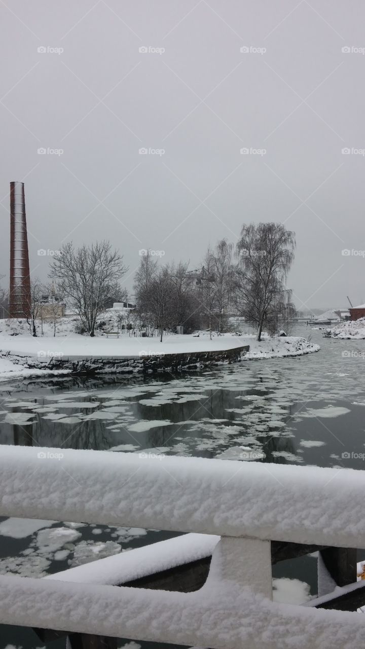A quiet, winter scene consisting of snow and ice in Suomenolinna, Helsinki, Finland.