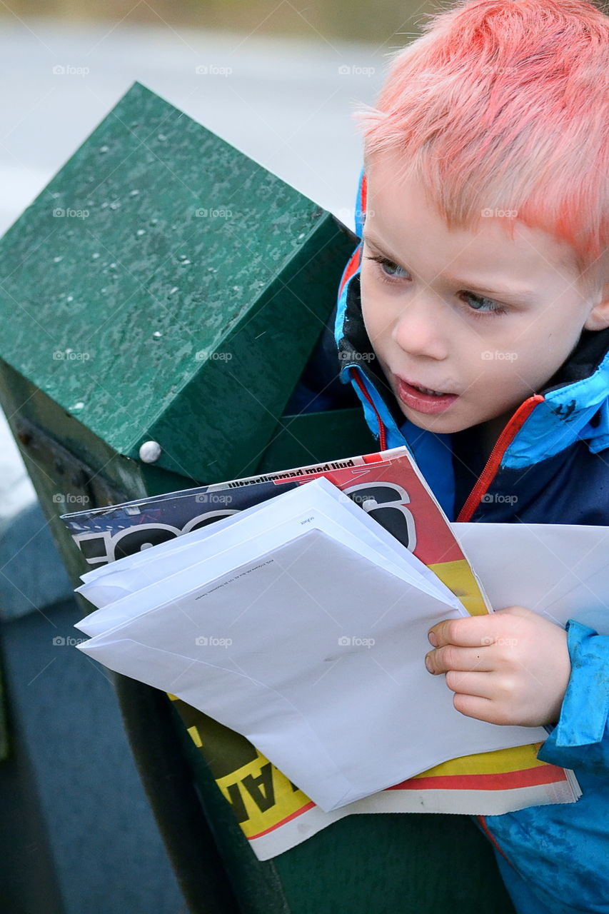 Boy getting letters from the mailbox