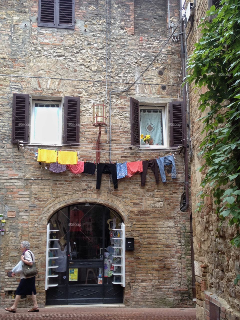 Laundry hanging on stone wall