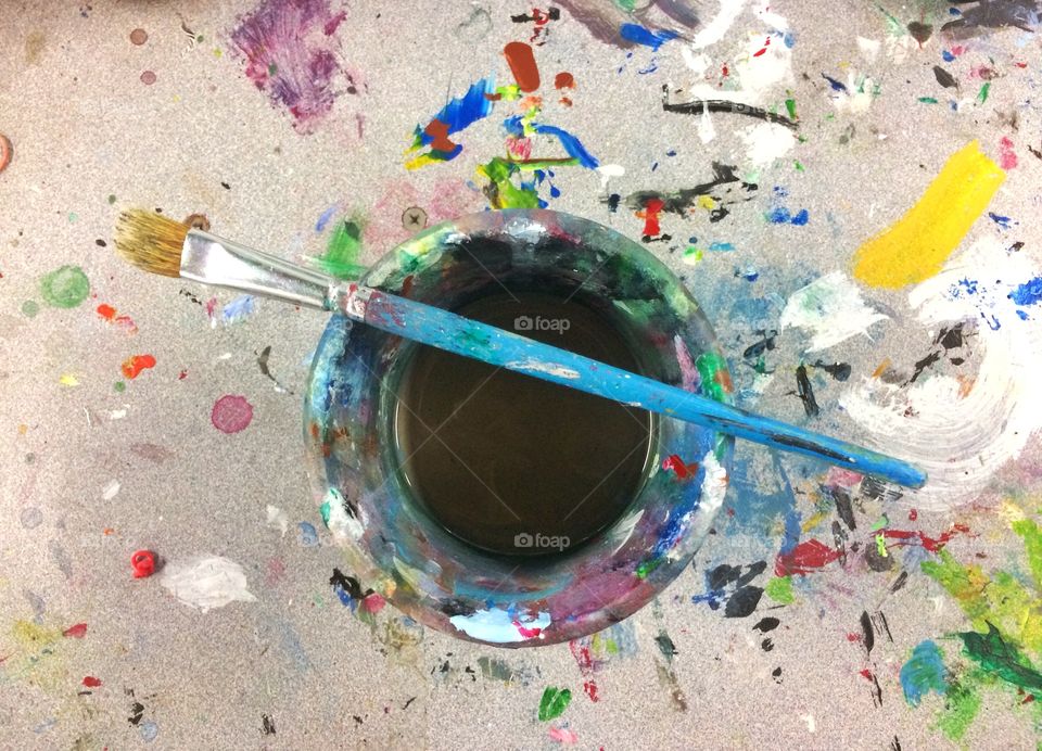 Messy paintbrush with container