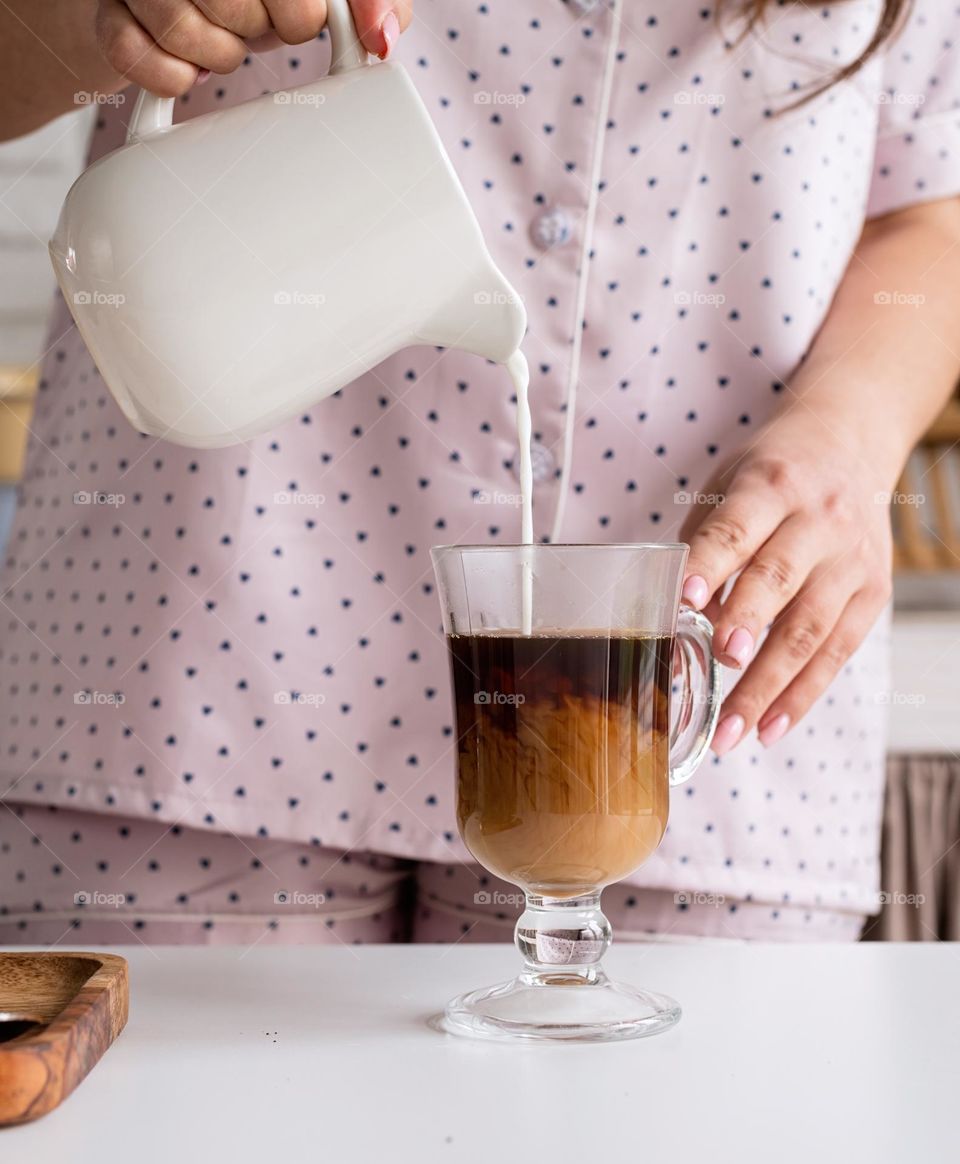 pouring milk to coffee