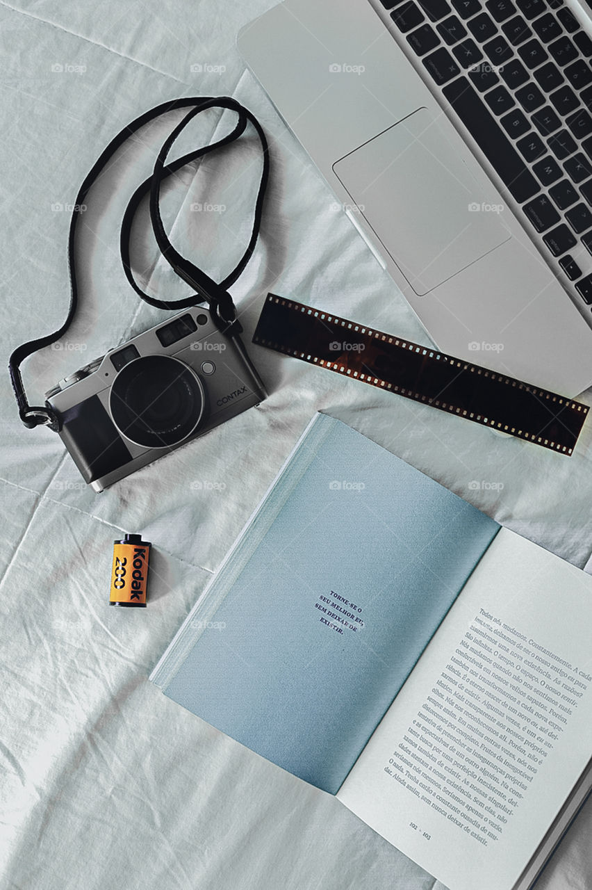 Flat lay film camera, book and computer
