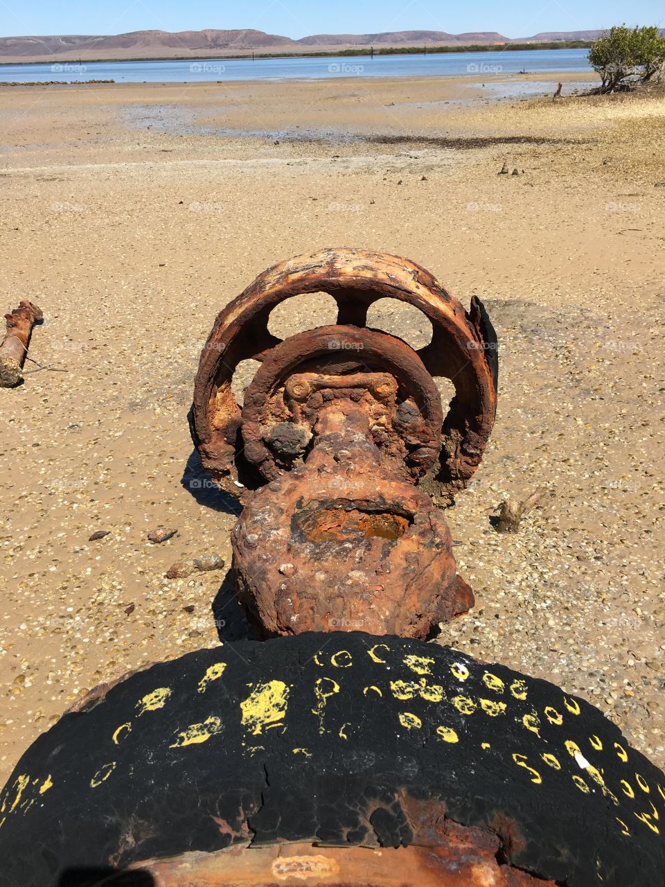 Rusty machinery washed up on shore at low tide south Australia 