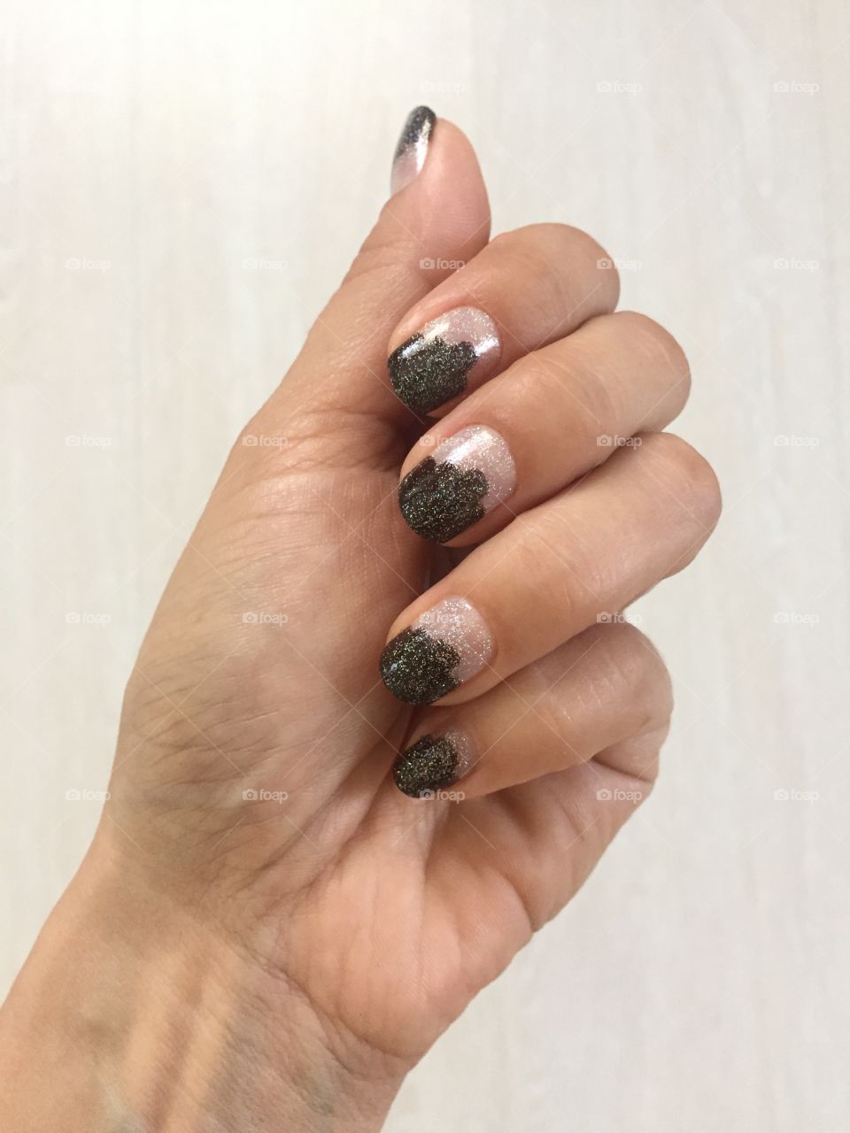 Manicure with dark brown stripes trimmed with silver tinsel