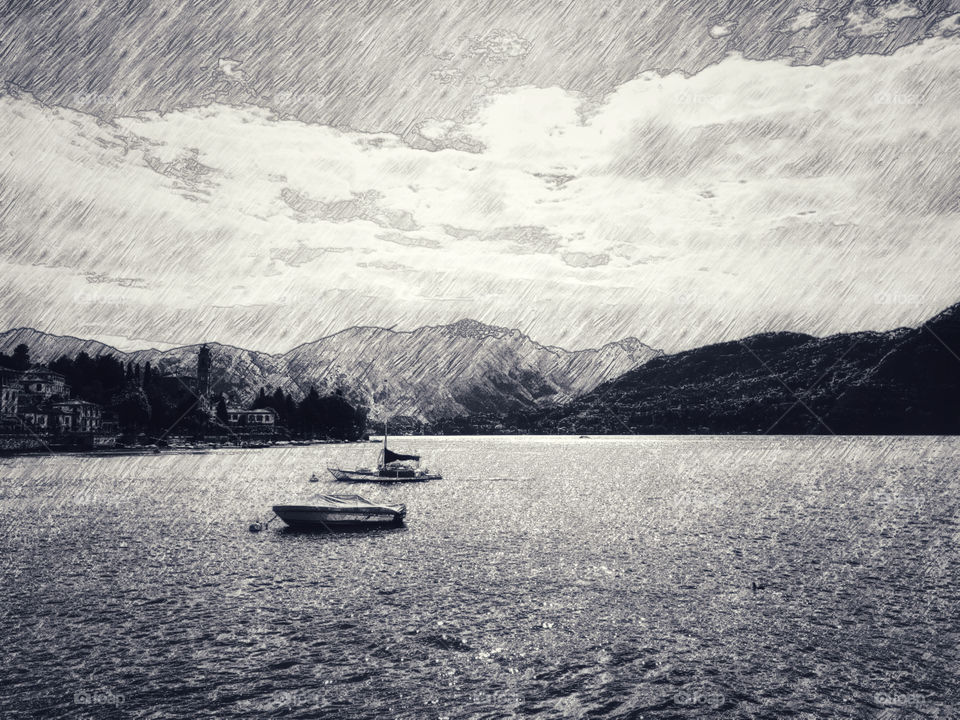 Pencil drawing sketch mountain, sky and sea view with and boats in Menaggio, Lake Como, Italy.