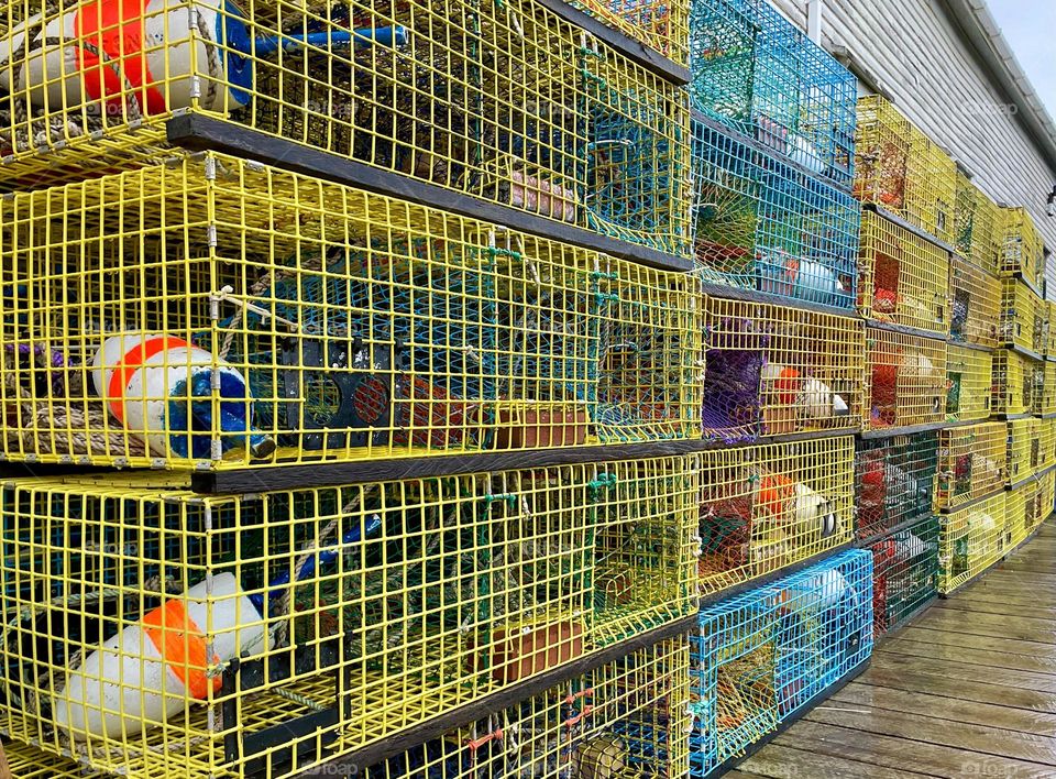 “Rainy Day stacks.” Colorful lobster traps line a wharf.