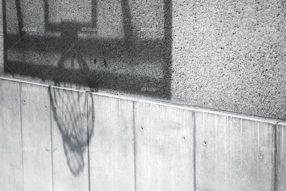 Basket ball hoop shadow against a wall in black and white - Pursuit of passion