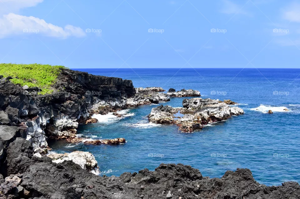 Along the beautiful ocean sea cliffs of lava rock on the east side of the Big Island of Hawaii.