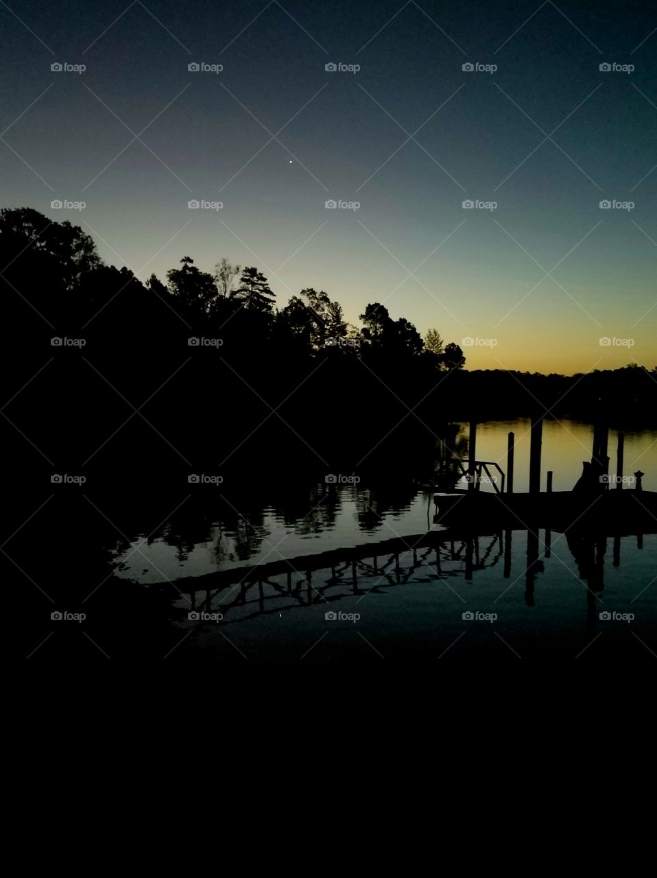 starlight reflecting from morning lake at sunrise