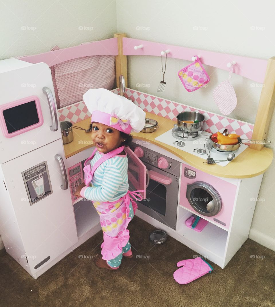 Elevated view of a girl standing in kitchen
