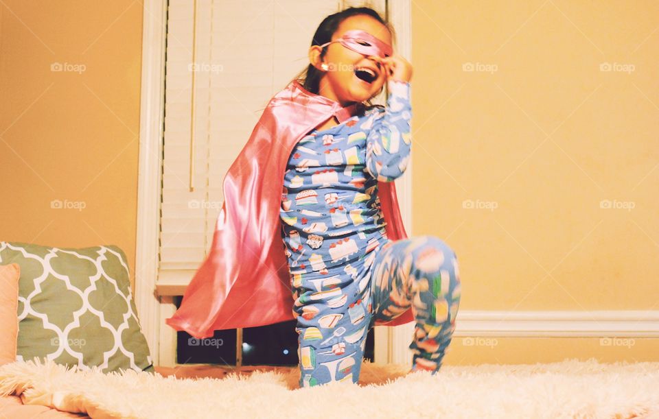 Little girl pretends to be superhero 