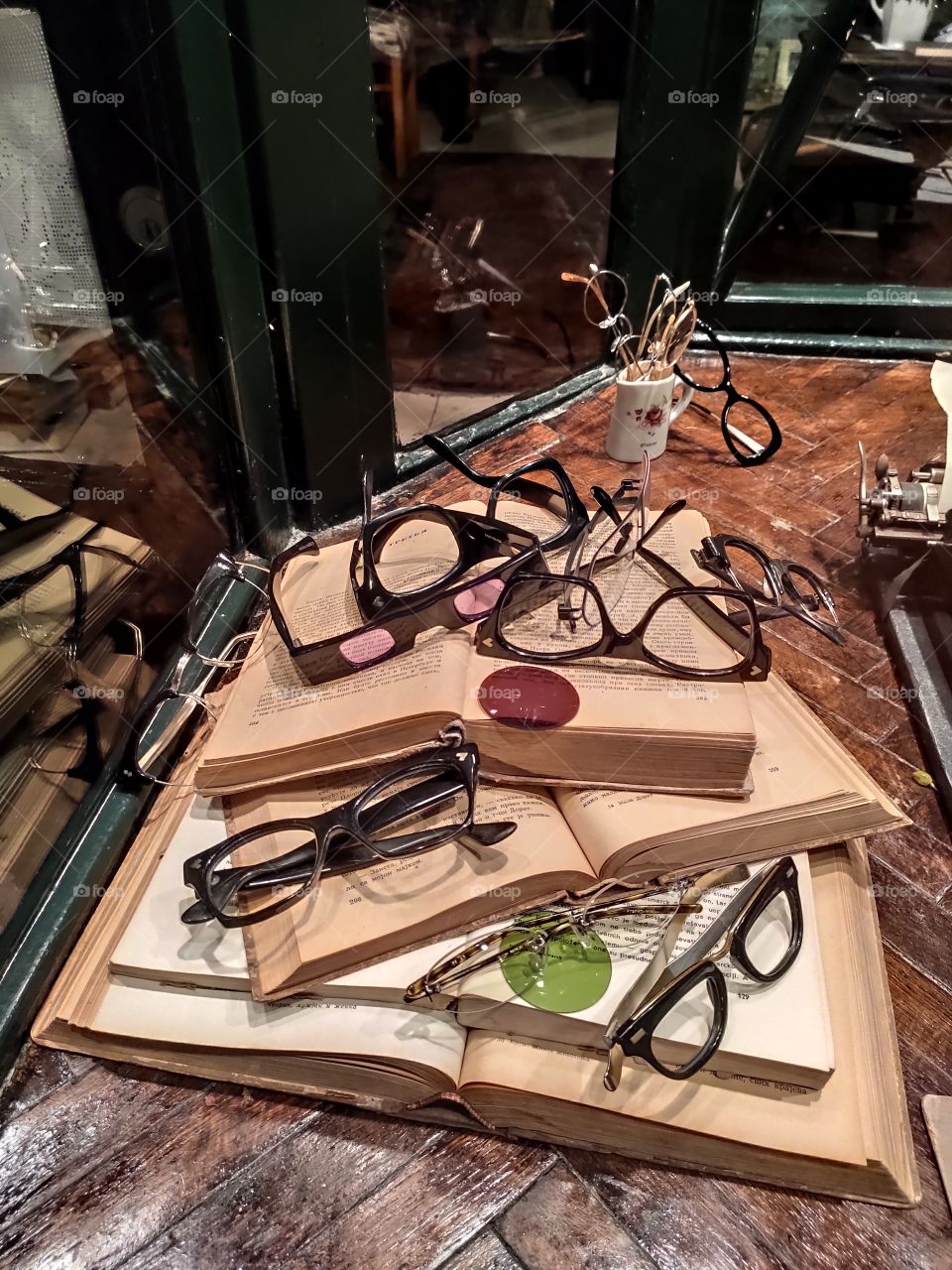 old books and glasses on the table