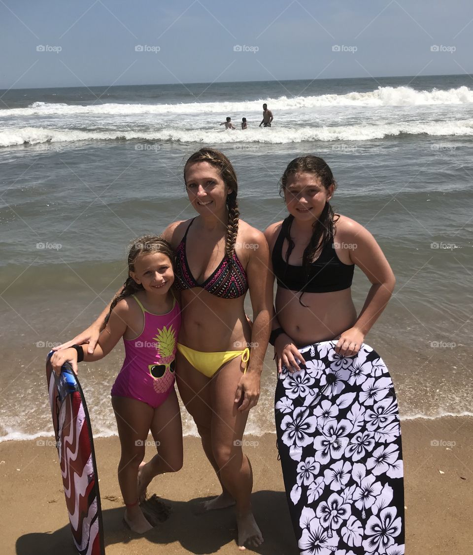 Riding some waves at the beach with my two daughters. Beach bums!