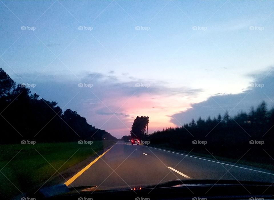 Travelling by car at Sunset
