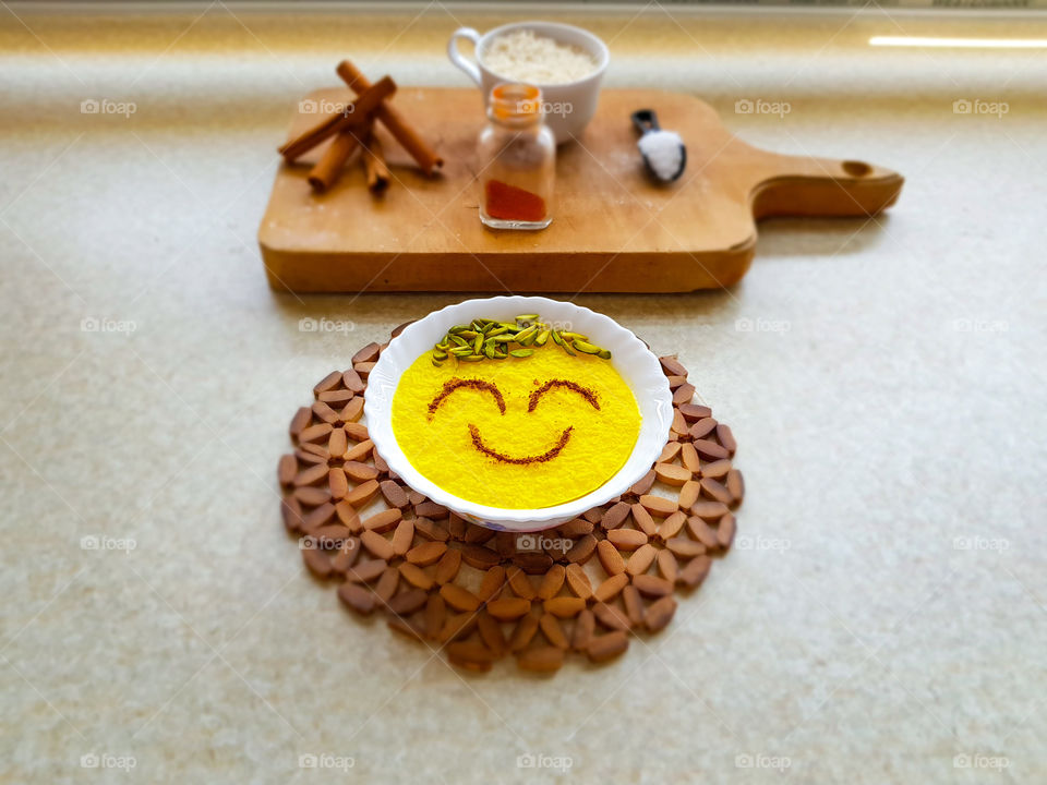 creating a delicious happy little dessert. sholezard, with the ingredients sugar, rice, cinnamon, saffron and some pistachios on top. I just love this dessert, decorating the top before eating it, is half the fun