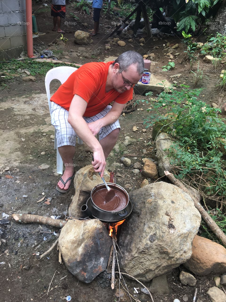 Man preparing food on campfire