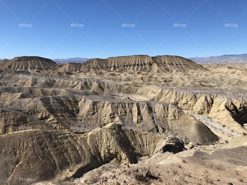 Elephant Knees Mountain in Anza Borrego Desert Park with arid  wasteland foreground hills and blue sky