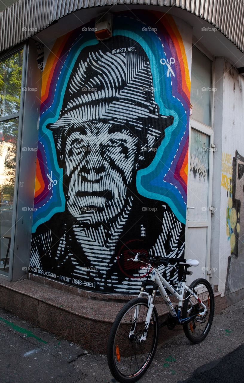 Bicycle in front of a mural in Bucharest