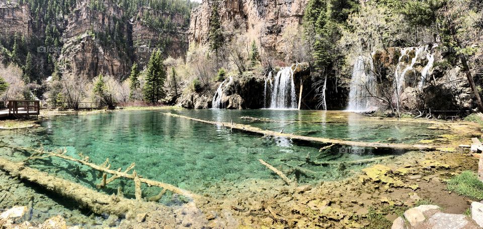 Beautiful crystal clear water flowing from a waterfall into a Colorado lake high in the mountains. 