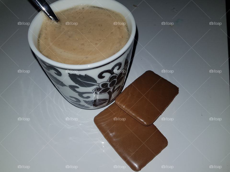 Nice cup of coffee, with sugar and milk. With matching coffee cookies, enjoy with the taste of coffee.