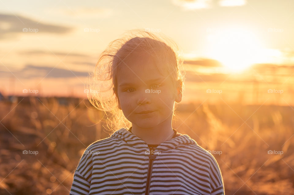 Little girl on the field in the village