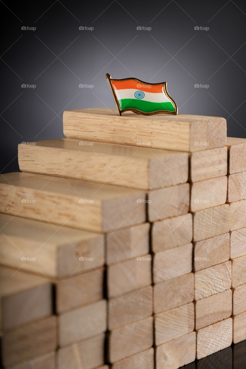 Putting India on top. Indian flag on top of wooden block stack