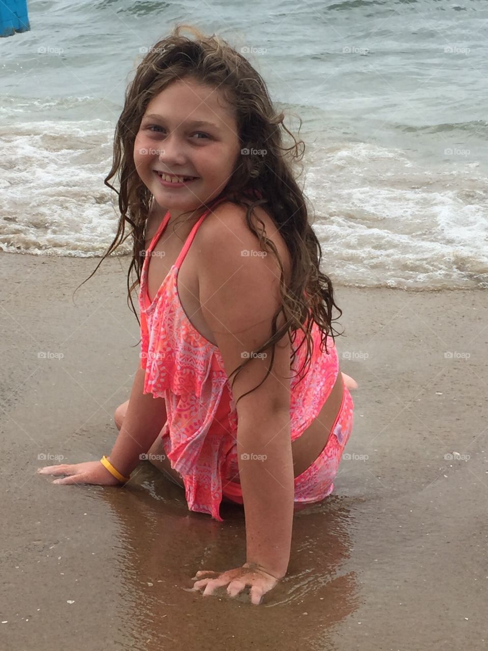 Pretty young girl relaxing in the waves. 