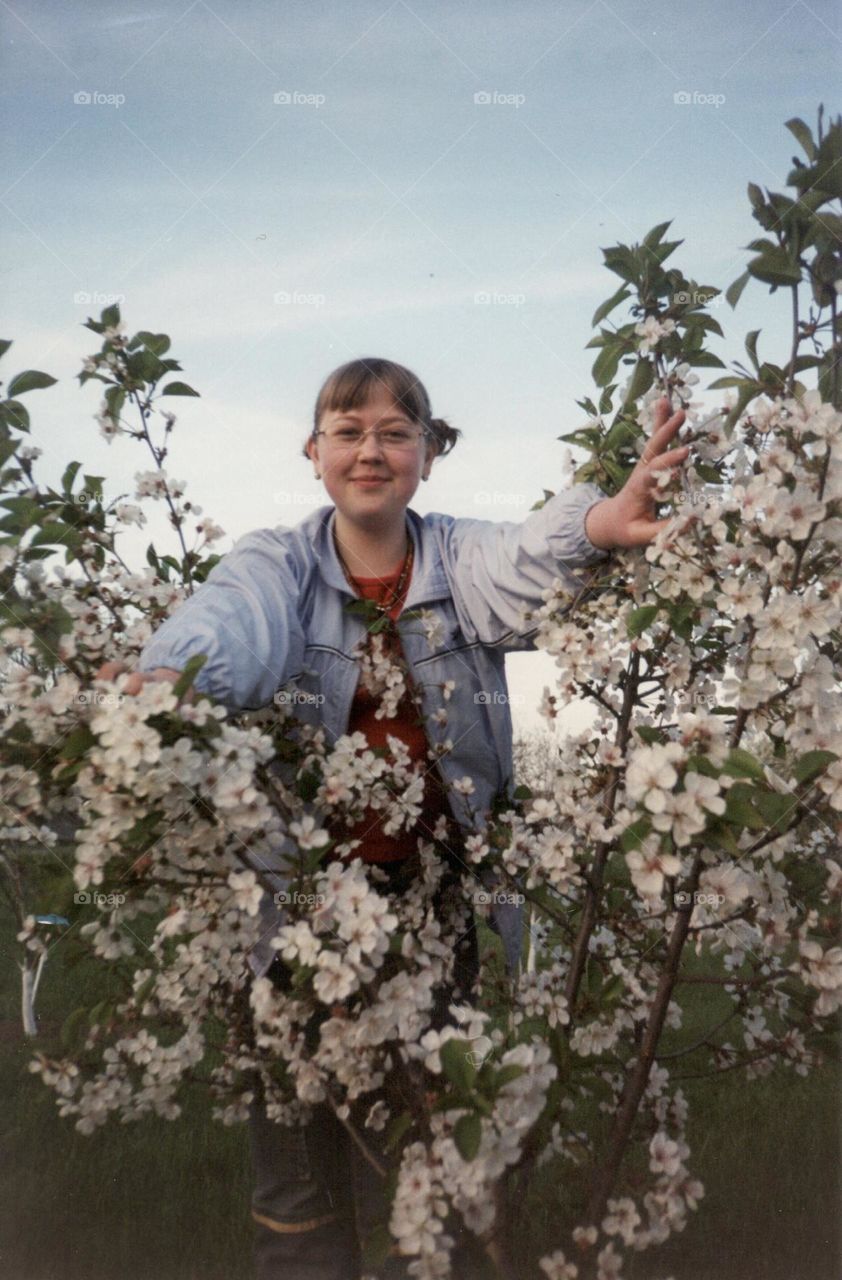 Flowering tree and smiling girl 