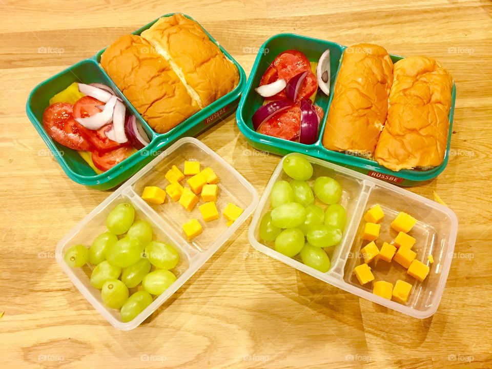 Balanced lunch bento grapes cheese turkey sandwiches vegetables