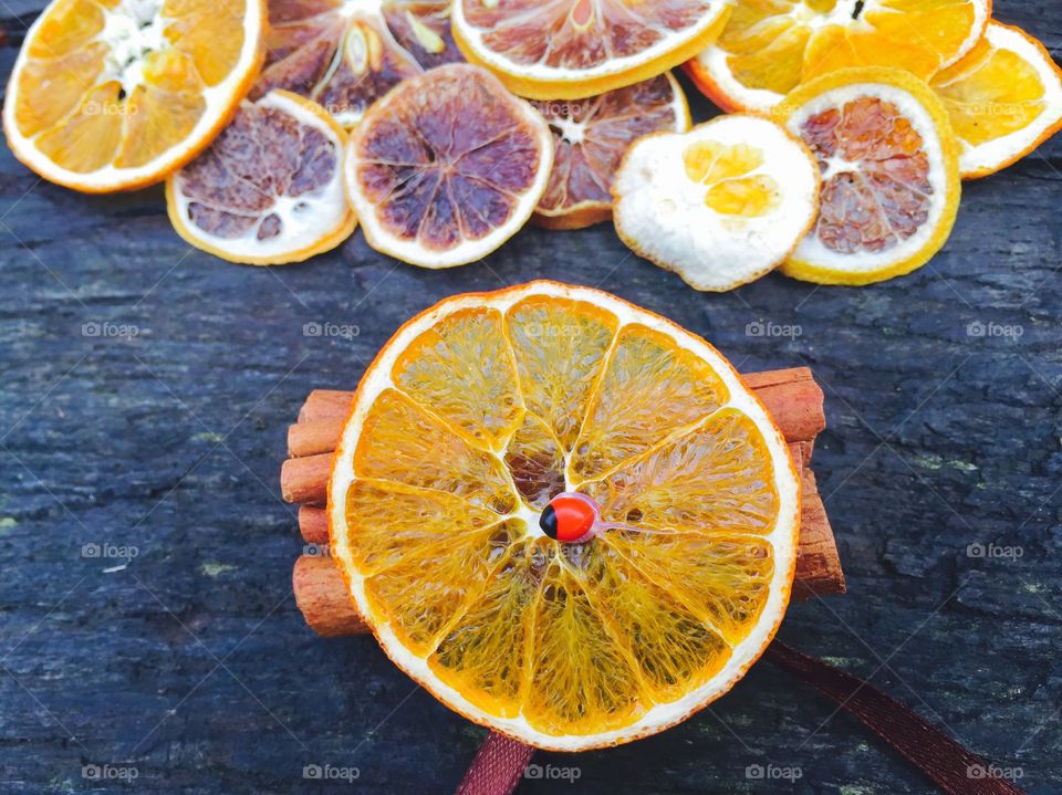 Sliced oranges with cinnamon stick