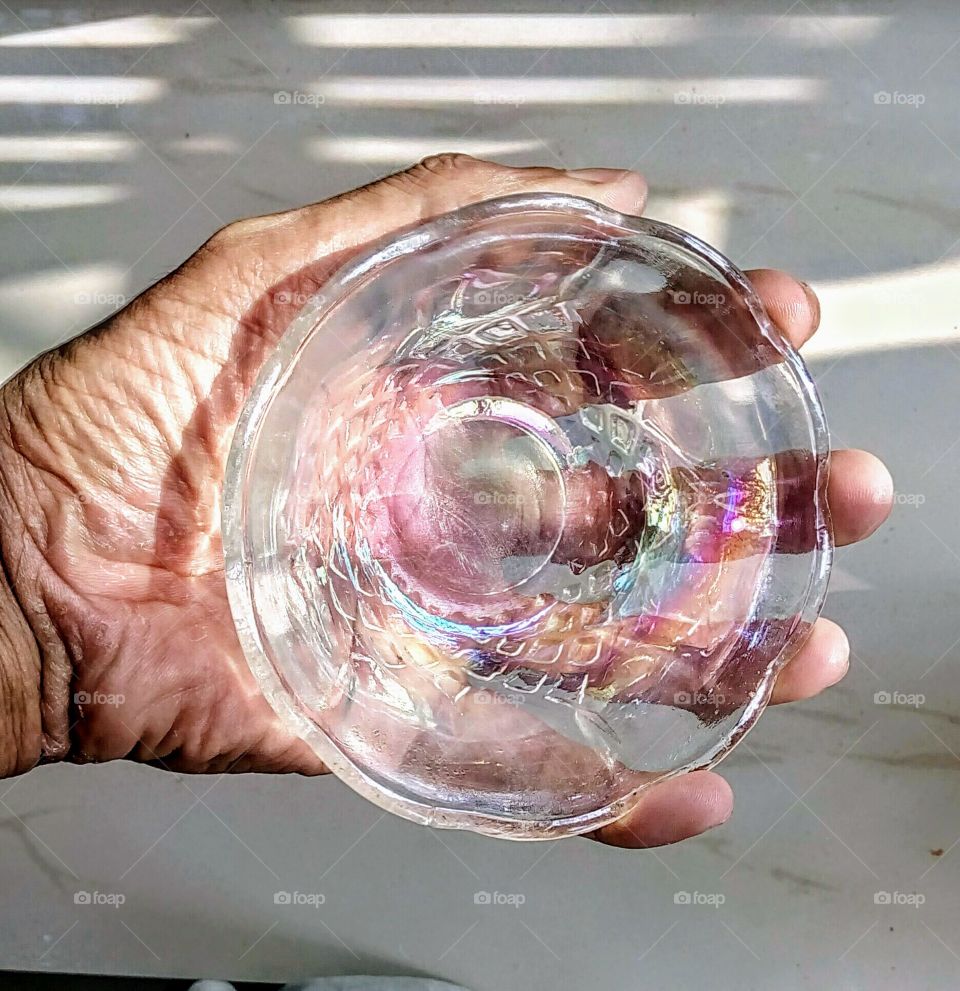 hand with glass bowl