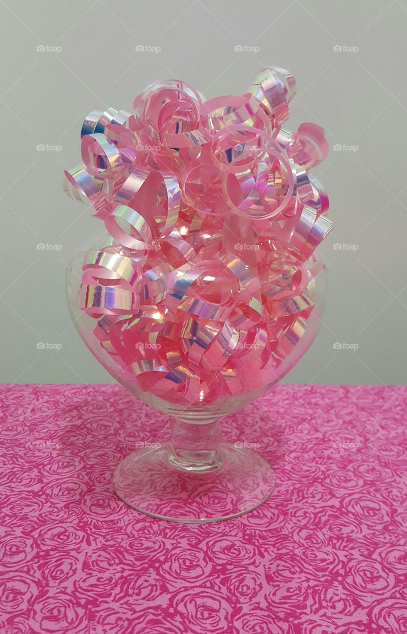 pink ribbon in an apothecary jar