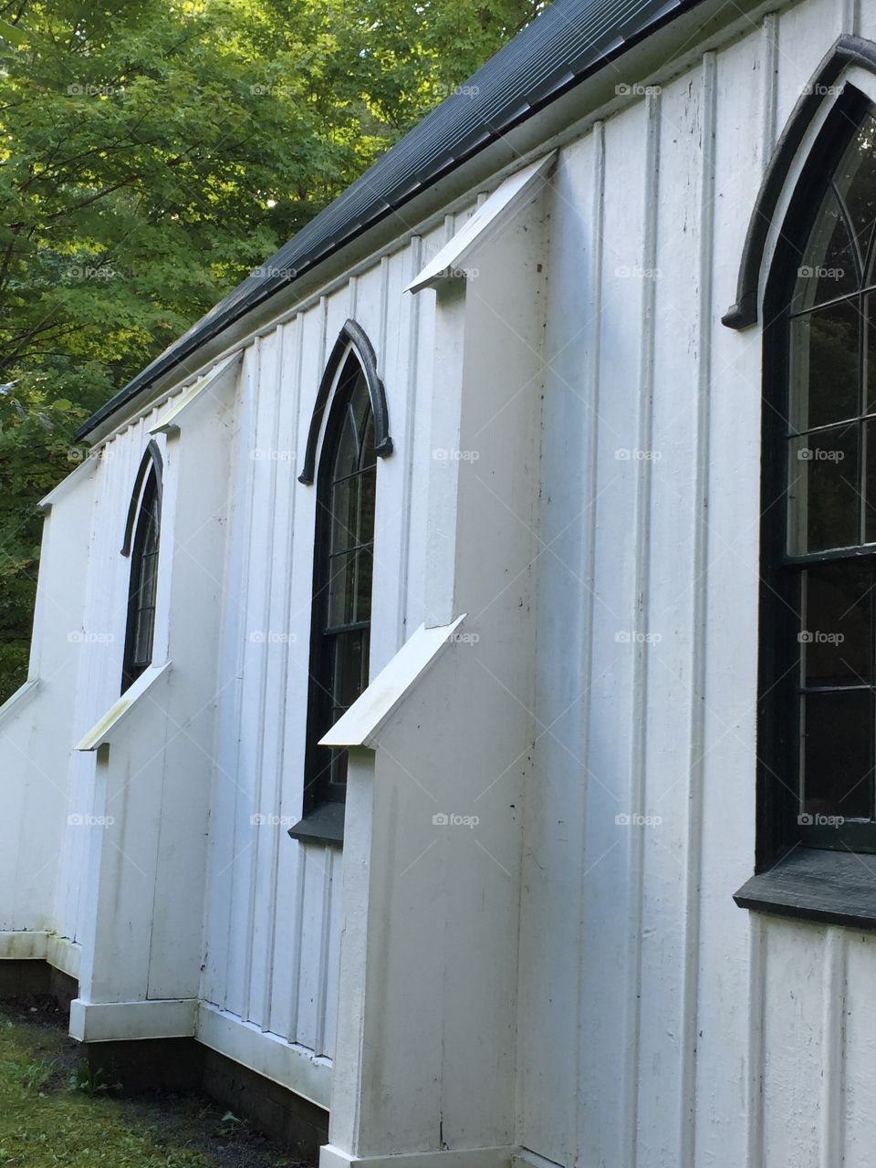 Side view of an old white church in Eagles Bay.  This church was moved to its present location in pieces and reassembled on its present site