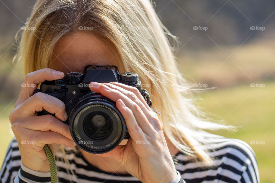 woman taking photos with a camera