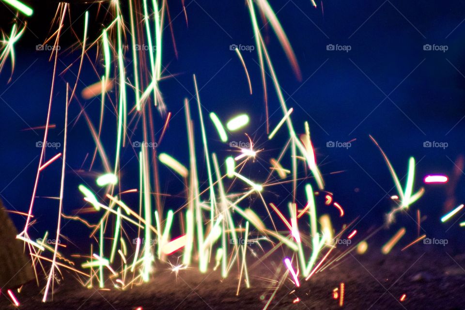 Closeup of sparks from a bench grinder being used on steel