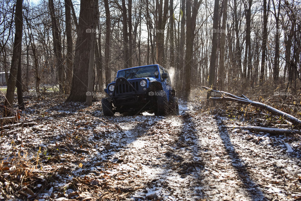blue jeep slinging mud