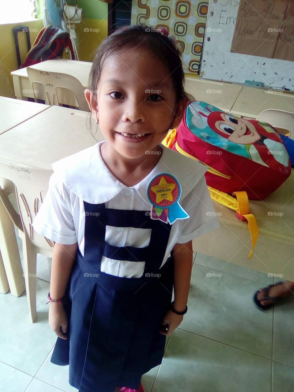 My amazing little 6 year old daughter showing a proud face, after starting her new school.