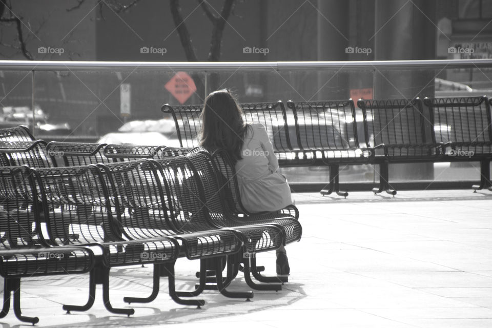 Women sitting alone, back and white, waiting