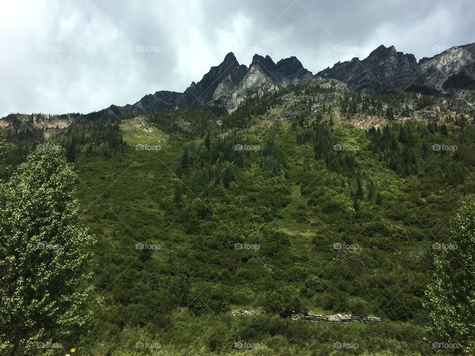 The mountains seem to touch the sky and beyond.