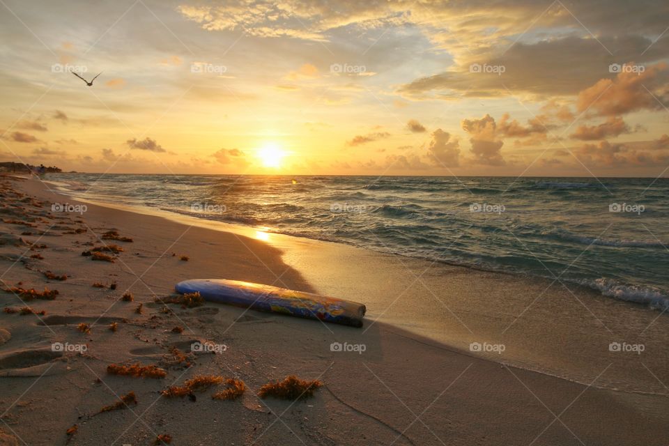 surf table on wet sand at sunrise