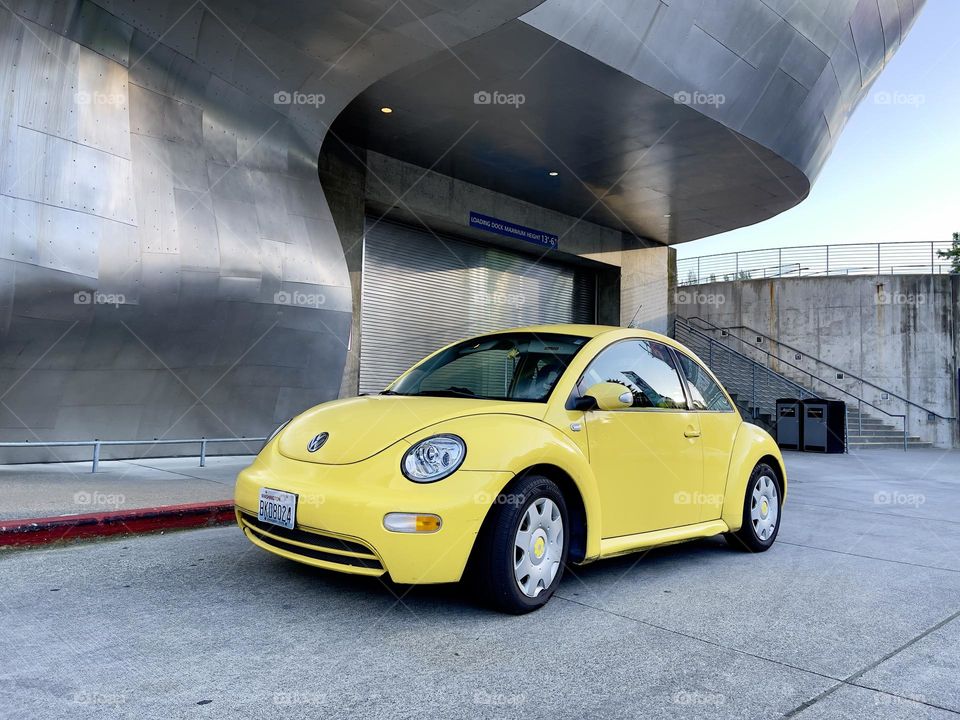 Yellow Volkswagen stands outside on the metal background 